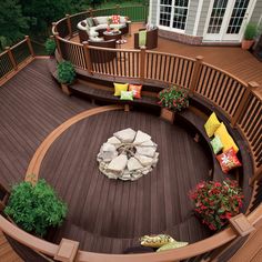 an outdoor deck with seating and fire pit