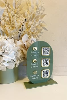 two vases with flowers and qr code on them