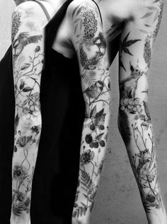 two people with tattoos on their arms