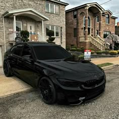 a black car parked in front of a house