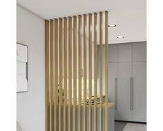 a room divider with wooden slats on the wall and white cabinets in the background