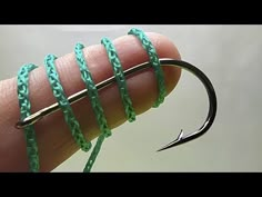 a fishing hook with green string wrapped around it