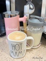 two coffee mugs sitting on top of a counter next to a blender and mixer