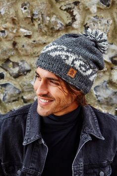 Men's Surf Bobble Beanie - A hand knitted wool hat for winter. Crashing wave sea design. Fair trade and handmade in Nepal Inspired by the crashing waves, our Surf design is perfect for coastal walks. The Surf bobble beanies are fleece lined around the forehead to keep your ears extra warm. 100% Wool Fleece lined around the forehead for comfort Fair Trade and Handmade in Nepal 100% Wool Outer, 100% Polyester Fleece Lining Machine wool wash max 30 degrees or cool hand wash. Quick spin. Dry flat. Do not tumble dry. One Size However, because our accessories are hand made no two are exactly alike. Have any exceptional size requests? Please place you order and message us in the 'Note to seller' Section. Please select the variation that you would like, please note you will only receive the variat Gray Hand Knitted Hat For Cold Weather, Handmade Outdoor Hat (one Size Fits Most), Winter 5-panel Snapback Hat For Outdoor, Outdoor Merino Wool Knitted Hat, Winter Outdoor 5-panel Snapback Hat, Outdoor Hand-knitted Beanie, Wool Hat Men, Hat For Winter, Men's Beanies