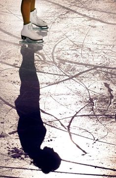 the shadow of a person on ice skates