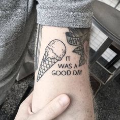 a man with a tattoo on his arm that says it was a good day and an ice cream cone