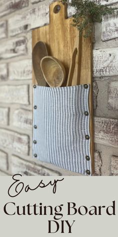 an easy diy cutting board holder with spoons and utensils in it