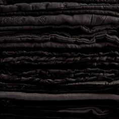 a pile of black cloths stacked on top of each other