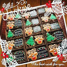 decorated christmas cookies in a box on a table