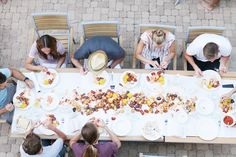 a group of people sitting around a table eating food