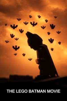 the lego batman movie poster with bats in the sky