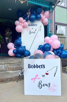 a sign that says bobbers or bones in front of some balloons and decorations on the sidewalk