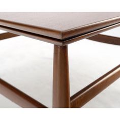 a close up of a wooden table on a white surface with no one around it