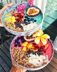 two bowls filled with fruit and granola on top of each other