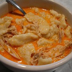 a white bowl filled with food on top of a table