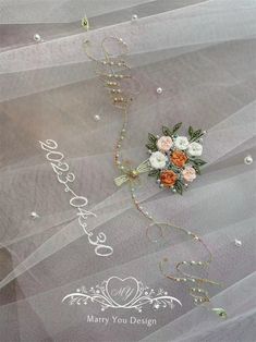 a bouquet of flowers sitting on top of a veil