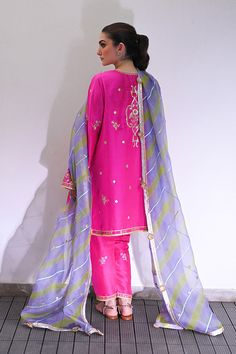 Channeling the old world charm of a kalidar kurta paired with shalwar, Serina is a striking hot pink number cut from pure rawsilk. The undulating trail of the geometric lime green and lavender contrasting organza dupatta hones in the ethereal aura. Model height: 5'3 Length: 38" Cut: relaxed fit In this price range, the Sania Maskatiya, Green And Lavender, Organza Shirt, Indian Designer Suits, Organza Dupatta, Price Range, Silk Dupatta, Silk Organza, Indian Designer