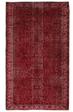 a red rug with an intricate design