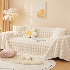 a white couch sitting on top of a hard wood floor