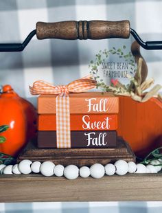 some pumpkins are sitting on top of boxes with ribbons and bows around the edges