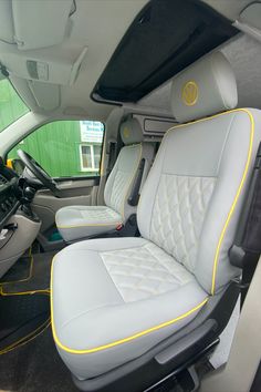 the interior of a vehicle with yellow stitching