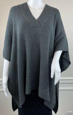 LOFT Charcoal Grey V-Neck Poncho Sweater - Pullover Style - 1/2” of Tack Stitch at Open Sides Create Arm Holes, Side is Completely Open Below Tack Stitching (see photos 3 & 6) - Folded Square/Rectangle Shape - Soft, Rib Knit Acrylic - Size Medium/Large New with tags Please see photos for details - M/L is shown on XS/S mannequin Tag Size: M/L Side to Side Poncho Width Measurement: 37” Top to Bottom Poncho Length Measurement: 28” #X238 One Size Knitted V-neck Sweater, One Size V-neck Knitted Sweater, Casual Gray Knit Poncho, Cozy Knit Poncho, Gray Knit Poncho For Fall, One Size Gray Knit Sweater, Textured Knit Poncho For Fall, Length Measurement, Poncho Sweater