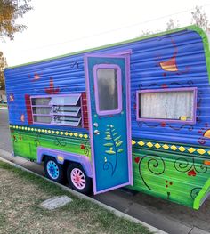 a colorful trailer is parked on the side of the road