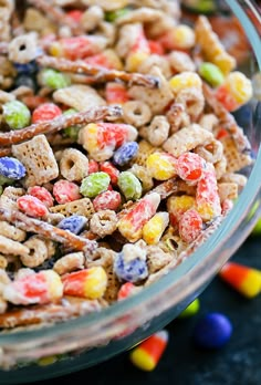 a glass bowl filled with cereal and candy