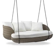 an outdoor swing chair with pillows on the front and back, hanging from two ropes