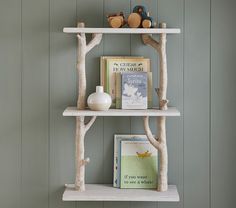 two white shelves with books and toys on them