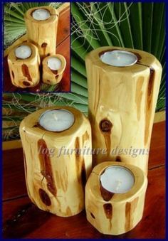 three wooden candle holders sitting on top of a table next to each other with candles in them