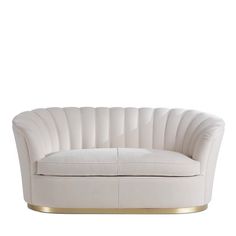 a white couch with gold trim on the legs and backrests, sitting in front of a white background