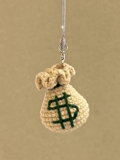 a small crocheted bag hanging from a chain