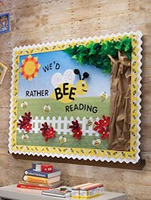 a bulletin board on the wall in a child's room with bees and flowers