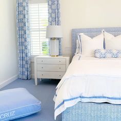 a bedroom with blue and white decor in it