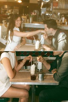 two people sitting at a table in a restaurant and one is holding the hand of another person's hand