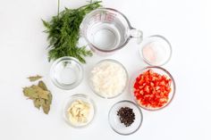 the ingredients to make this dish include tomatoes, onions, and other things in small glass bowls