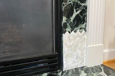 a black and white marble counter top next to a door