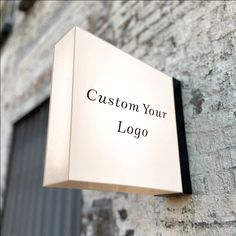 a sign on the side of a building that says custom your logo in black ink