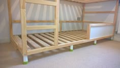 there is a bunk bed with no mattresses in the room, but it has green legs