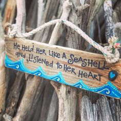 a wooden sign that says he held her like a seashell and listened to her heart