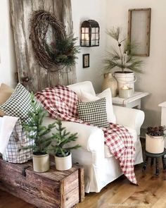 a living room filled with furniture and christmas decorations on top of wooden crates in front of a window