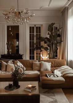 a living room filled with furniture and a chandelier