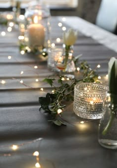 a long table with candles and flowers on it