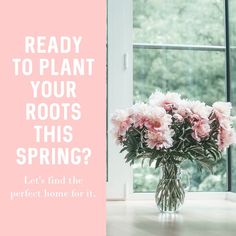 a vase filled with pink flowers sitting on top of a table next to a window