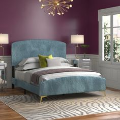 a bedroom with purple walls, zebra rug and blue upholstered bedspread