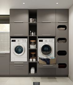 a washer and dryer in a small room with shelves on the wall behind them