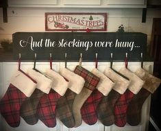 stockings hanging on a rack with christmas stocking hung from it's hooks and saying, and the stockings were hung