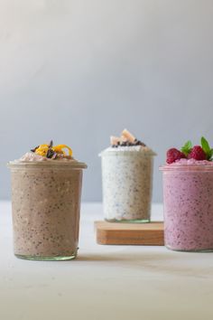 three small jars filled with different types of food