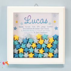 a white frame with blue and yellow stars in the center that says lucas on it